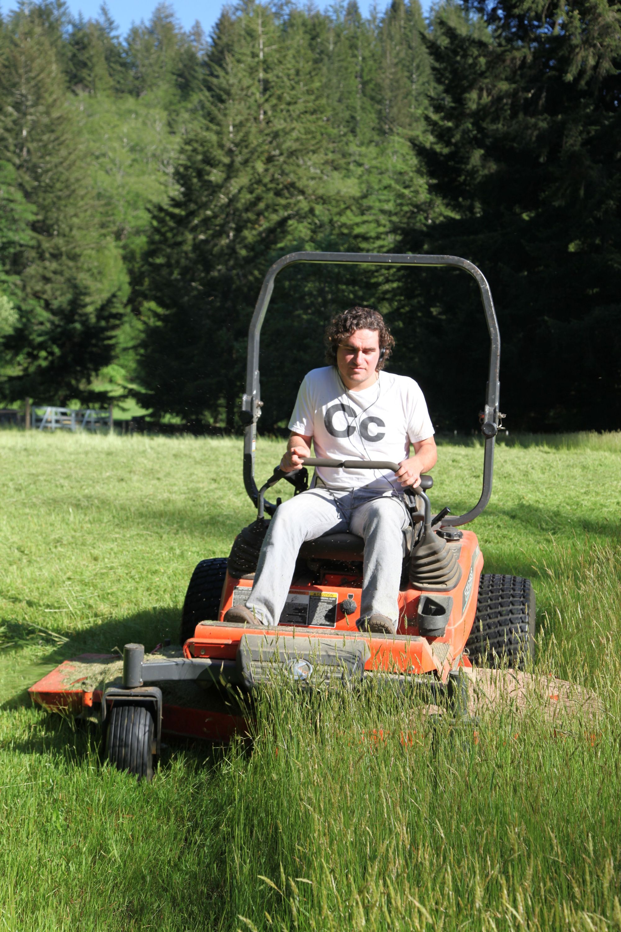 Commercial zero-turn mower cutting a large green lawn